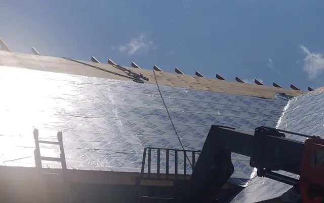 Example photo: Self-adhered ice and water membrane in overlapping sheets on a roof deck, running up from the eave